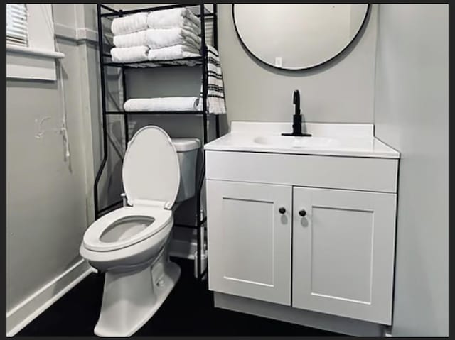 bathroom with vanity and toilet