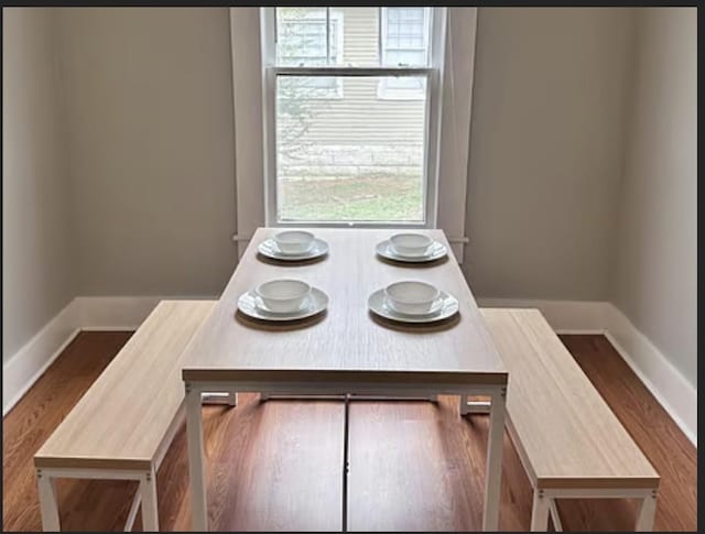 dining space with dark hardwood / wood-style flooring