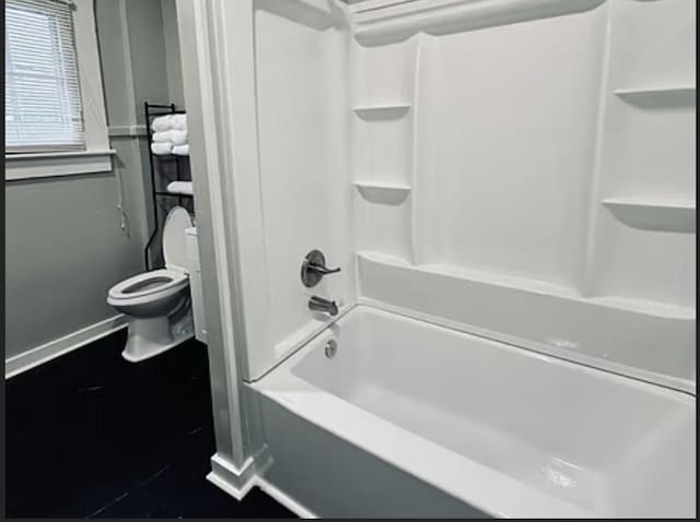 bathroom featuring  shower combination and toilet