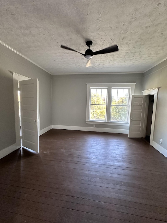 spare room with dark hardwood / wood-style flooring, ceiling fan, ornamental molding, and a textured ceiling