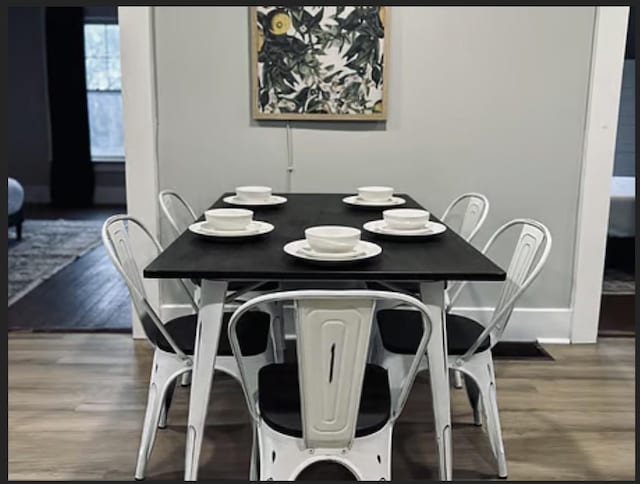 dining space featuring wood-type flooring