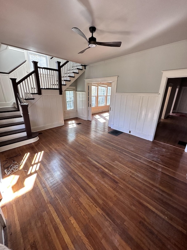 unfurnished living room with ceiling fan and dark hardwood / wood-style floors