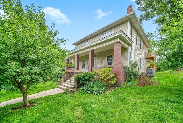 440 N 2nd St, Clarksville, TN 37040 - view of front of home featuring a chimney, a porch, central AC, a front yard, and brick siding