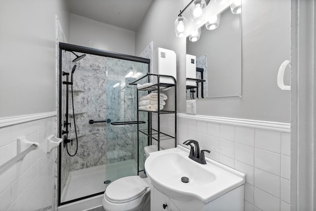 440 N 2nd St, Clarksville, TN 37040 - full bath with tile walls, a stall shower, vanity, toilet, and a wainscoted wall