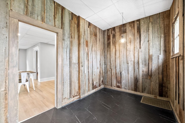 440 N 2nd St, Clarksville, TN 37040 - empty room with wooden walls, a paneled ceiling, and baseboards