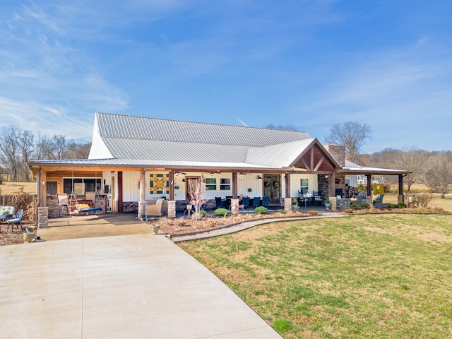 rear view of house with a porch and a lawn