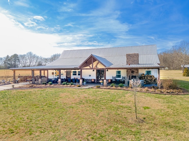 rear view of house with a patio and a yard