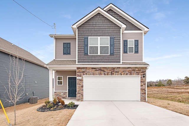 view of front of house with a garage and central AC unit