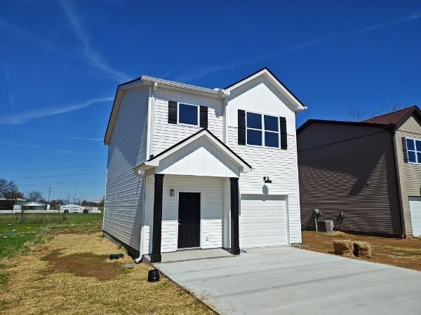 view of front of house with a garage and central AC