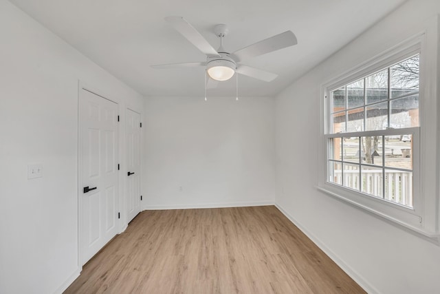 spare room with ceiling fan and light hardwood / wood-style flooring