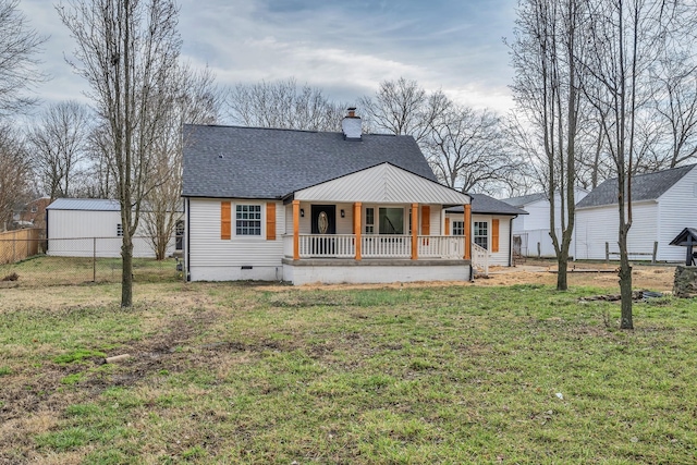 back of house with covered porch and a lawn