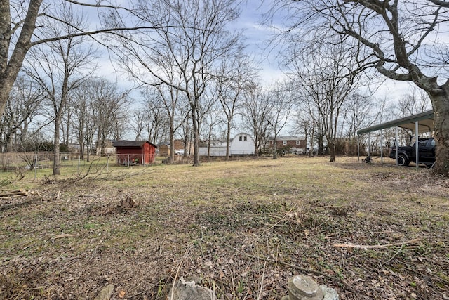 view of yard featuring a carport and a storage shed