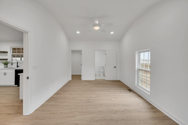 hallway featuring sink and light wood-type flooring