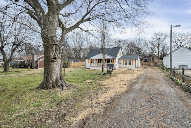 single story home with a front yard and a porch