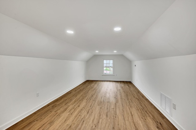 bonus room featuring lofted ceiling and light wood-type flooring