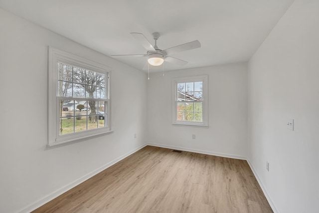 spare room featuring light hardwood / wood-style flooring and ceiling fan