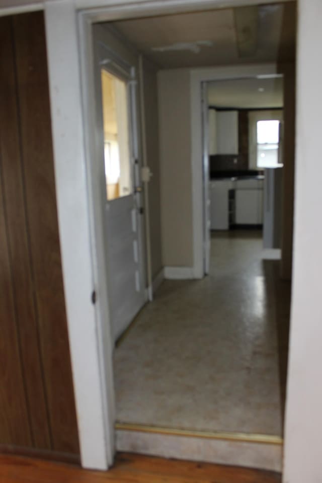hallway featuring baseboards