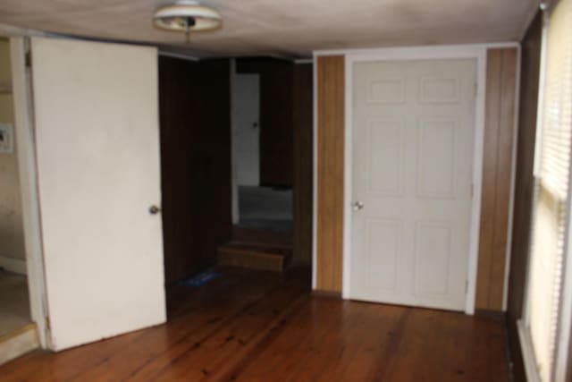 unfurnished bedroom featuring a closet and wood finished floors