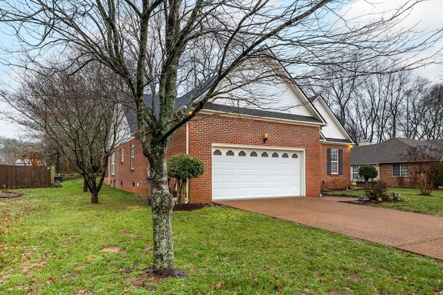 view of front of home with a garage and a front lawn