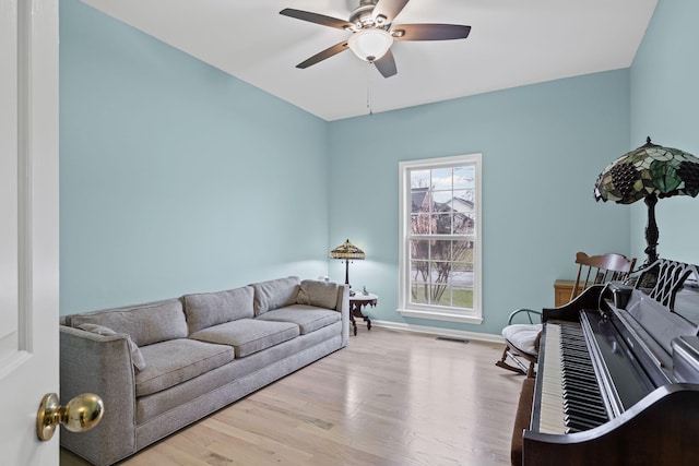 living room featuring ceiling fan and light wood-type flooring