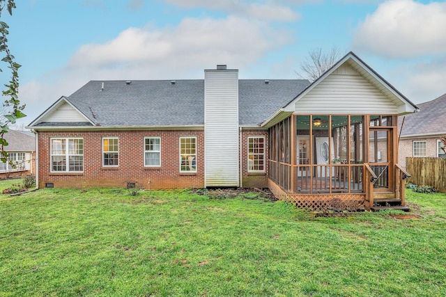 back of property featuring a lawn and a sunroom