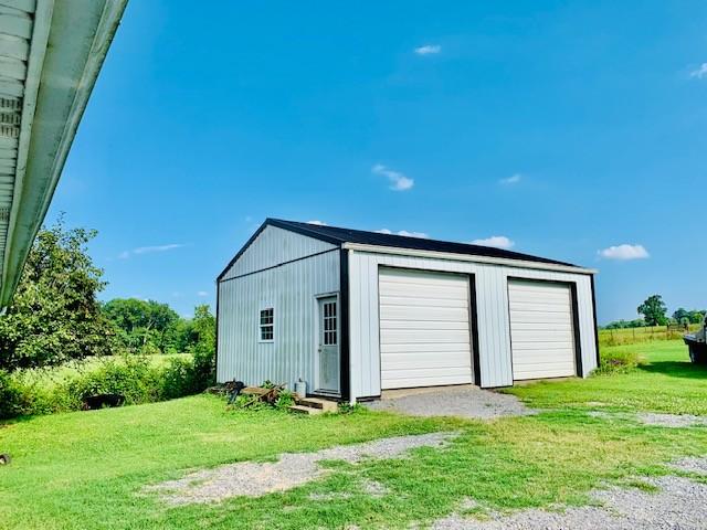 view of outdoor structure with a garage and a yard