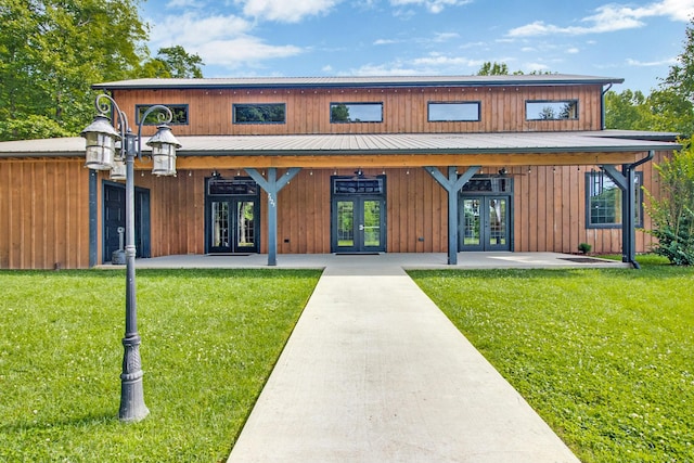 back of property featuring french doors and a yard