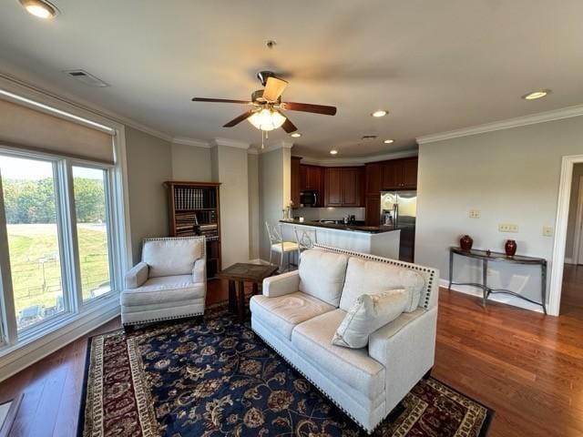 living room featuring crown molding, dark hardwood / wood-style floors, and ceiling fan