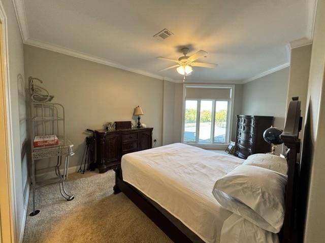 bedroom with crown molding, light colored carpet, and ceiling fan