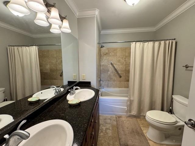 full bathroom with shower / tub combo with curtain, vanity, and crown molding