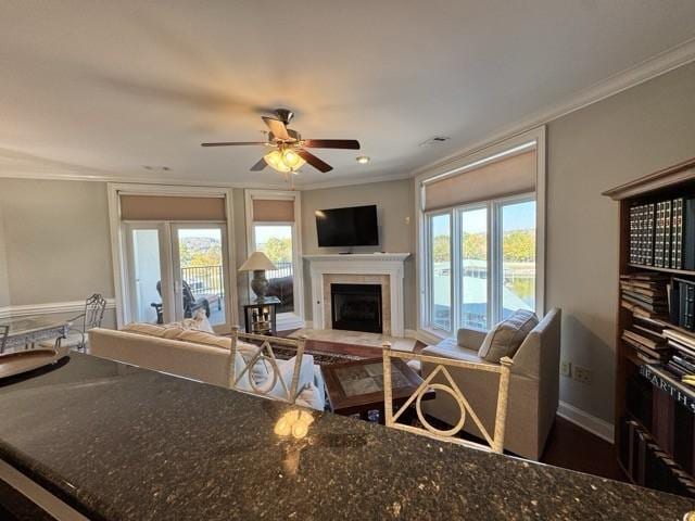 living room with crown molding and ceiling fan