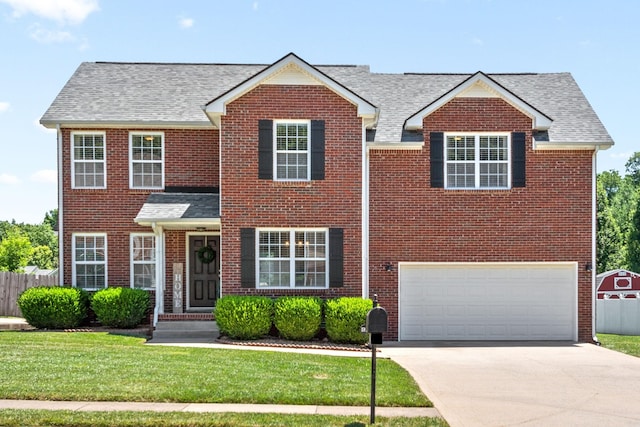 view of front facade with a garage and a front yard