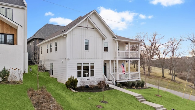 view of front of property with a balcony and a front lawn