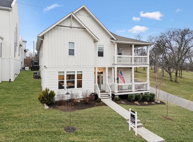 view of front of house with board and batten siding, a balcony, covered porch, and a front yard