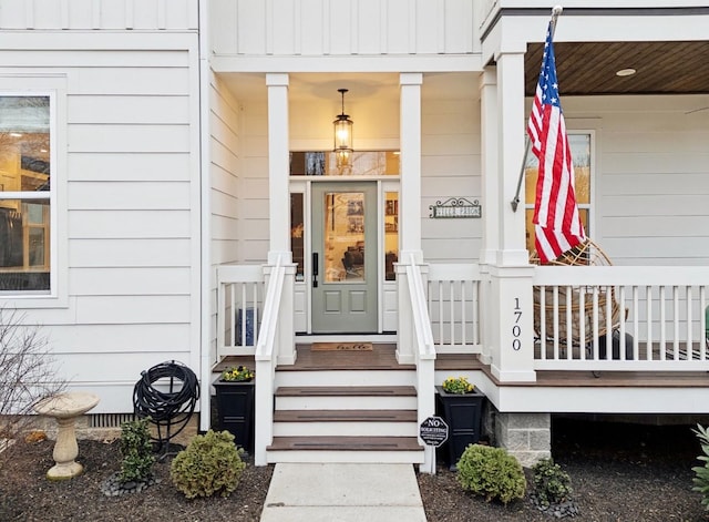 entrance to property featuring board and batten siding and covered porch