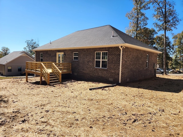 rear view of house with a wooden deck and french doors