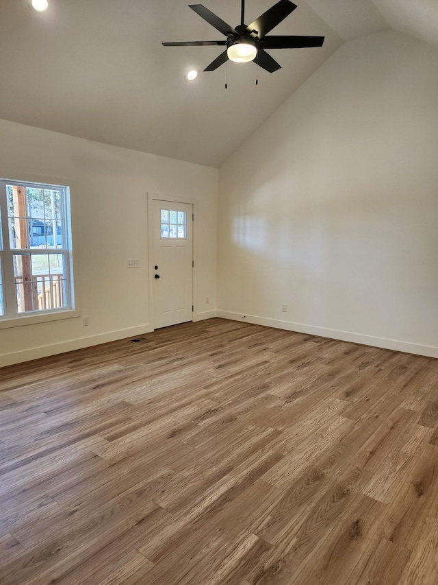 foyer featuring high vaulted ceiling, ceiling fan, and light wood-type flooring