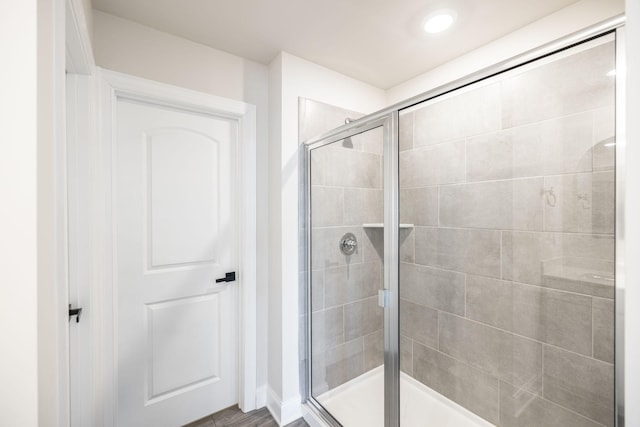 bathroom featuring a shower with shower door