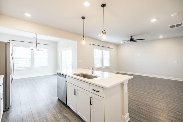 kitchen with white cabinetry, sink, hanging light fixtures, a kitchen island with sink, and stainless steel appliances