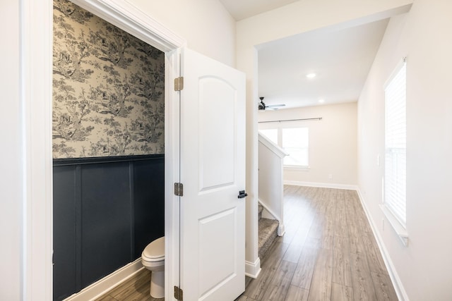 bathroom featuring hardwood / wood-style flooring and toilet