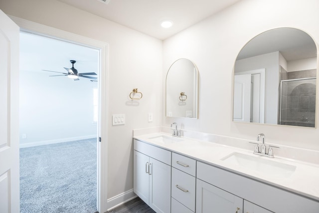 bathroom featuring vanity, a shower, and ceiling fan