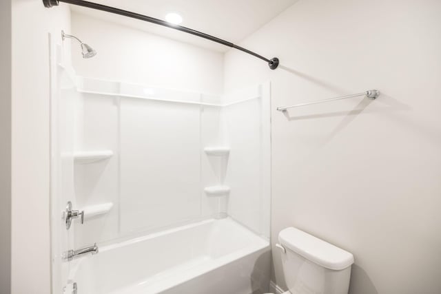 bathroom featuring bathtub / shower combination and toilet