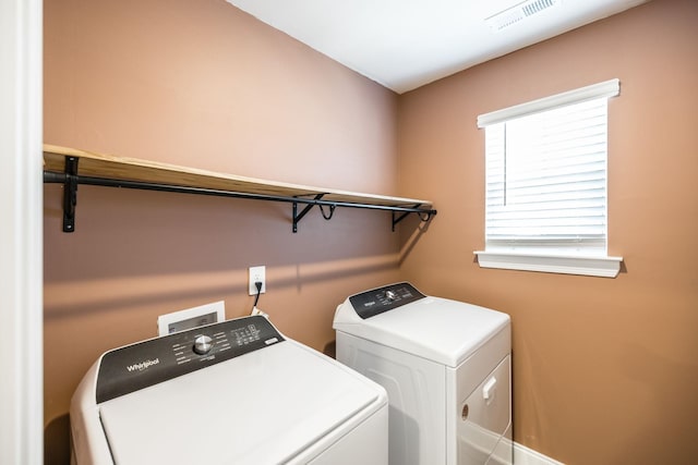 clothes washing area featuring washing machine and clothes dryer