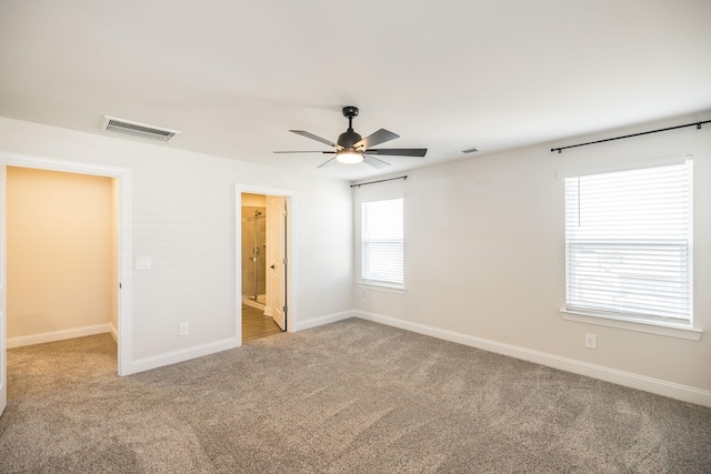 carpeted spare room with ceiling fan