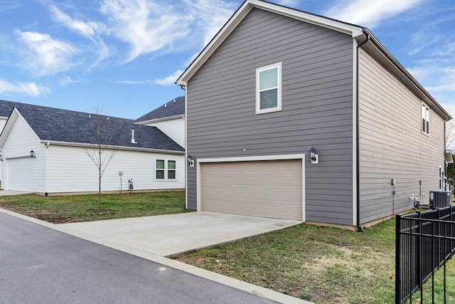 exterior space featuring cooling unit, a garage, and a yard