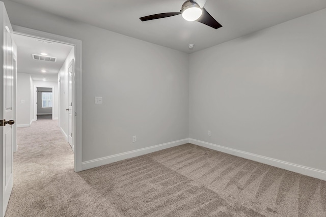 carpeted spare room with ceiling fan