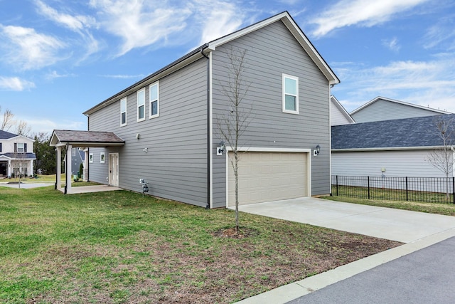 view of side of property featuring a garage and a yard