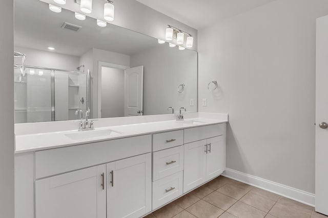 bathroom with vanity, a shower with shower door, and tile patterned floors