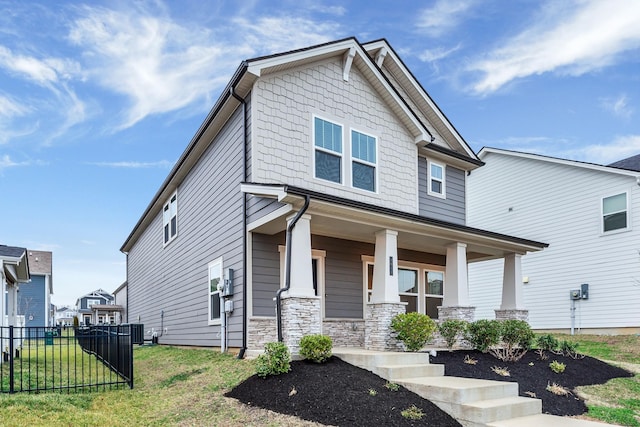 craftsman-style home with a porch and a front yard