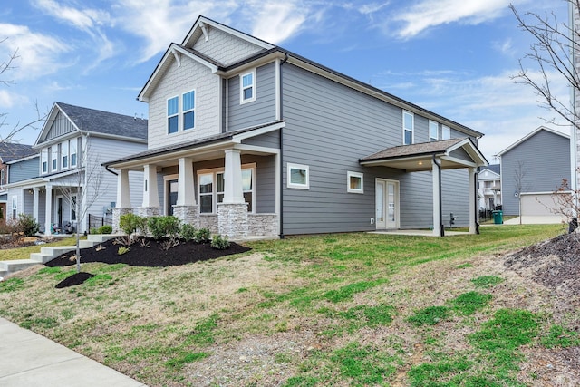 view of front of house with covered porch and a front lawn